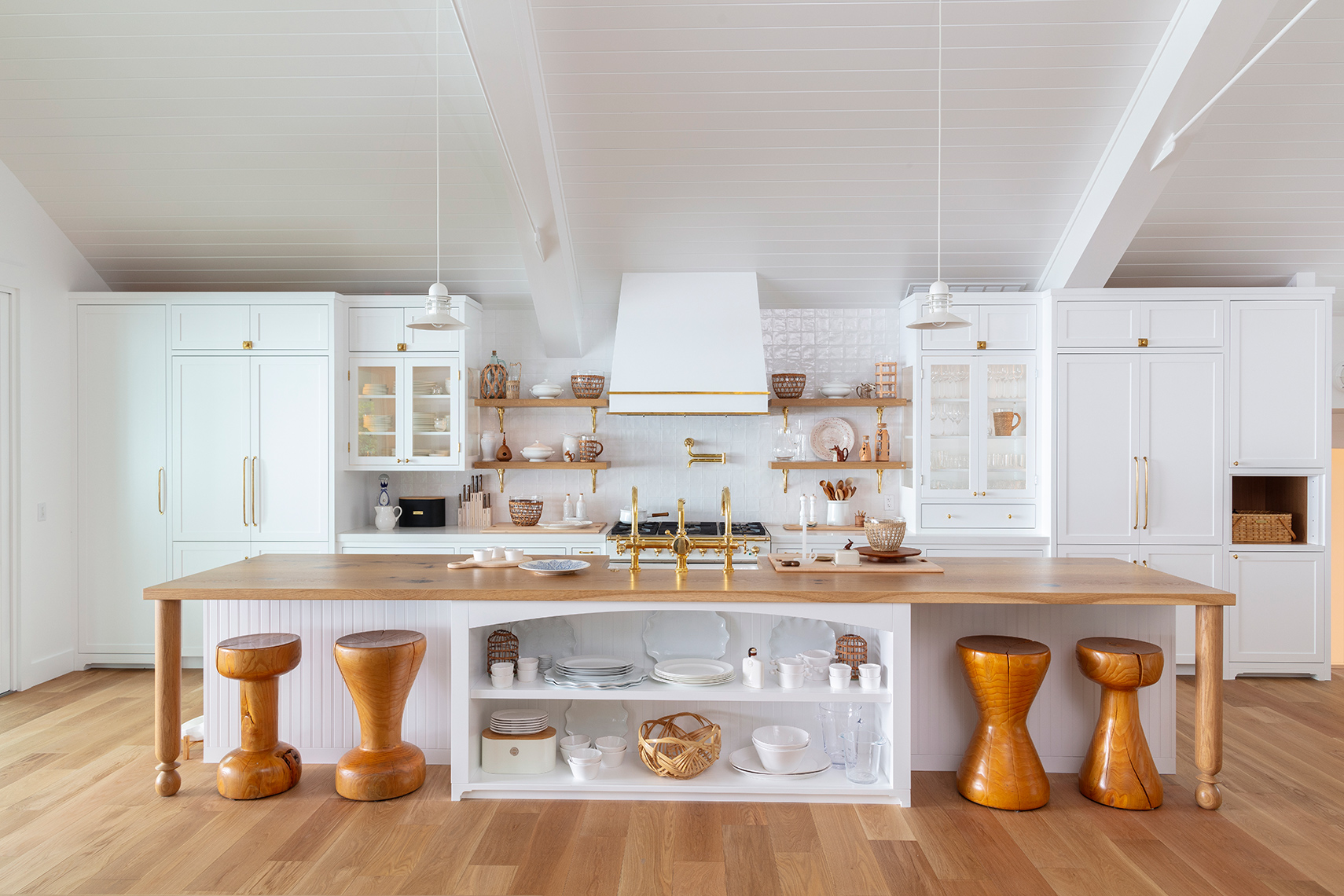 Scandanavian brass and warm wood white cabinet lakeside kitchen 